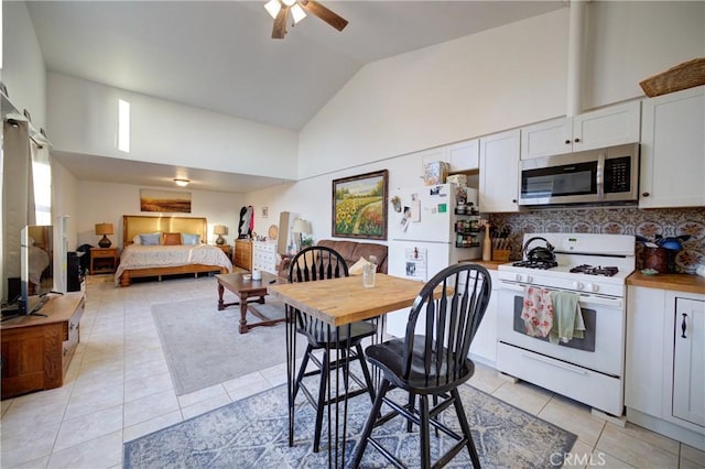 1160 Easy Ln, Nipomo, CA 93444 - kitchen featuring white appliances, light tile patterned floors, backsplash, ceiling fan, and high vaulted ceiling