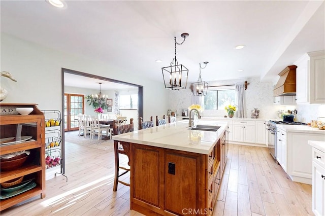 1160 Easy Ln, Nipomo, CA 93444 - kitchen with a sink, stainless steel range, a chandelier, premium range hood, and plenty of natural light
