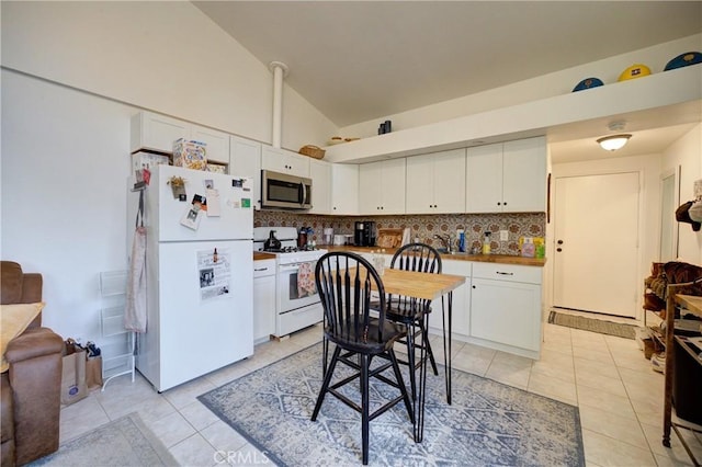 1160 Easy Ln, Nipomo, CA 93444 - kitchen featuring white appliances, light tile patterned flooring, white cabinetry, tasteful backsplash, and high vaulted ceiling
