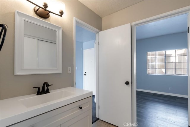 3913 N Virginia Rd Unit 207, Long Beach, CA 90807 - bathroom with vanity, a textured ceiling, and wood finished floors