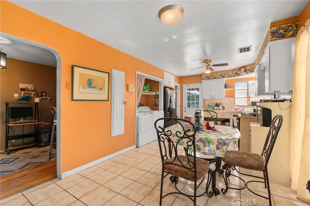 650 N Acacia, Rialto, CA 92376 - dining space with washing machine and dryer, ceiling fan, arched walkways, and light tile patterned floors