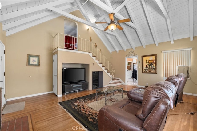 650 N Acacia, Rialto, CA 92376 - living area featuring stairway, wood finished floors, ceiling fan, high vaulted ceiling, and a wooden ceiling with exposed beams