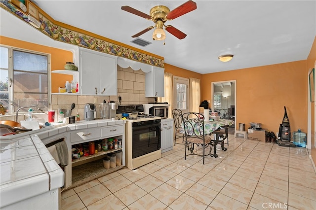 650 N Acacia, Rialto, CA 92376 - kitchen with white gas range oven, tile countertops, open shelves, and a ceiling fan