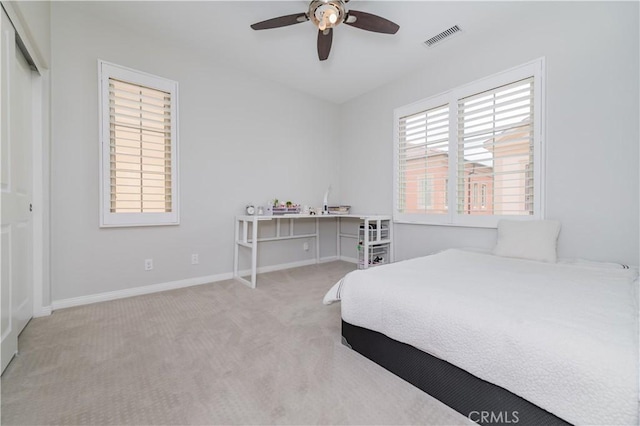 bedroom featuring baseboards, visible vents, ceiling fan, and carpet