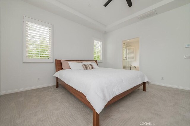 bedroom featuring baseboards, ceiling fan, light colored carpet, and visible vents