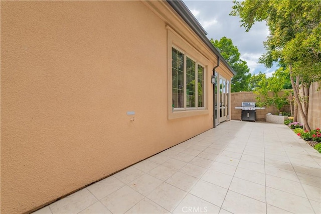 view of patio / terrace with fence and a grill