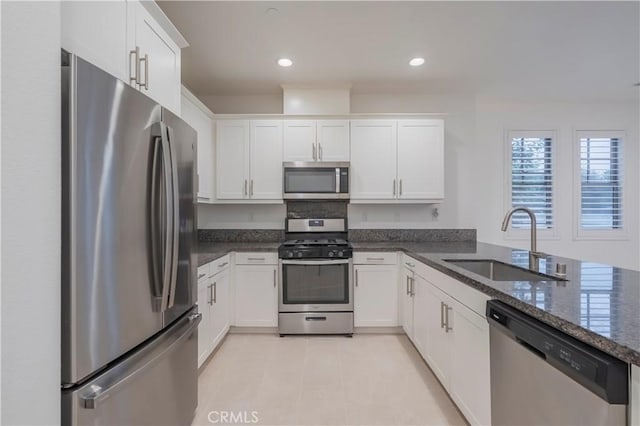 556 W Baseline Rd, Claremont, CA 91711 - kitchen featuring recessed lighting, dark stone counters, appliances with stainless steel finishes, white cabinets, and a sink