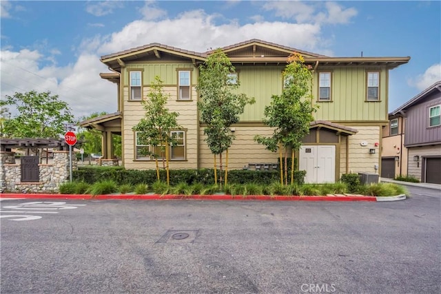 556 W Baseline Rd, Claremont, CA 91711 - view of front of house with board and batten siding, central AC unit, and driveway