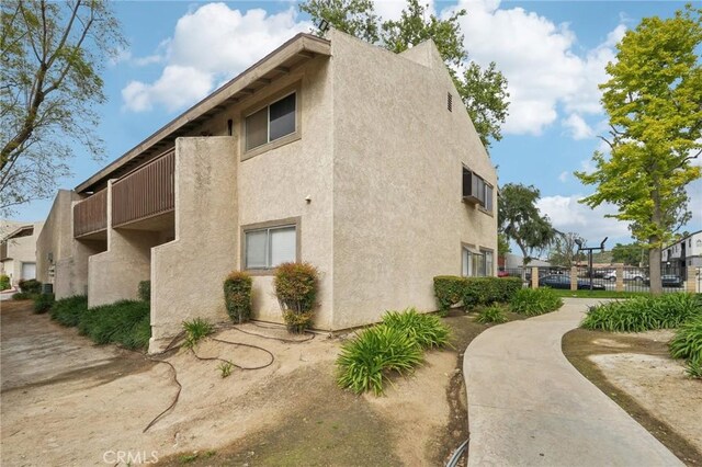 1251 S Meadow Ln Unit 154, Colton, CA 92324 - view of side of property with fence and stucco siding