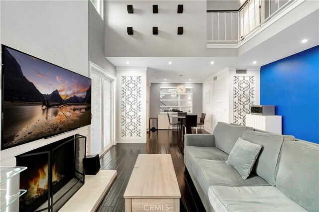 1541 Westcastle, West Covina, CA 91791 - living room featuring a high ceiling, wood finished floors, recessed lighting, and a warm lit fireplace