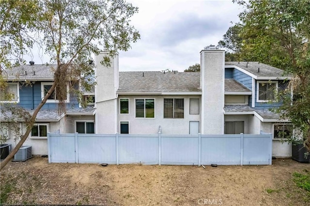 1541 Westcastle, West Covina, CA 91791 - back of property with a chimney, fence, roof with shingles, and stucco siding