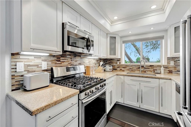 1541 Westcastle, West Covina, CA 91791 - kitchen with appliances with stainless steel finishes, a sink, ornamental molding, backsplash, and white cabinetry