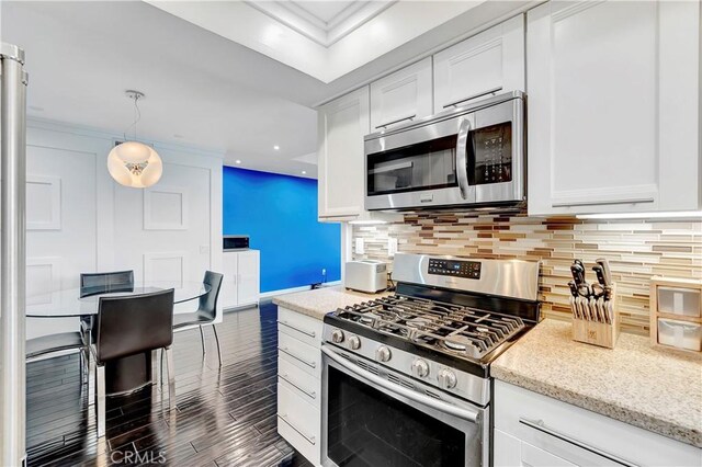 1541 Westcastle, West Covina, CA 91791 - kitchen featuring appliances with stainless steel finishes, white cabinetry, dark wood-type flooring, tasteful backsplash, and light stone countertops