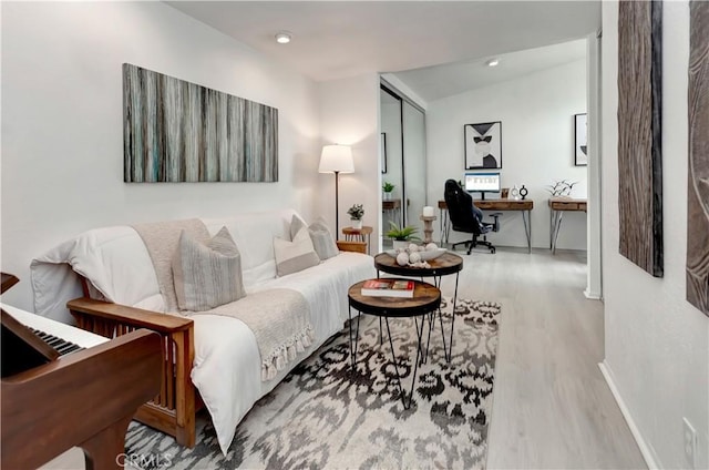 living room featuring baseboards, recessed lighting, wood finished floors, and vaulted ceiling