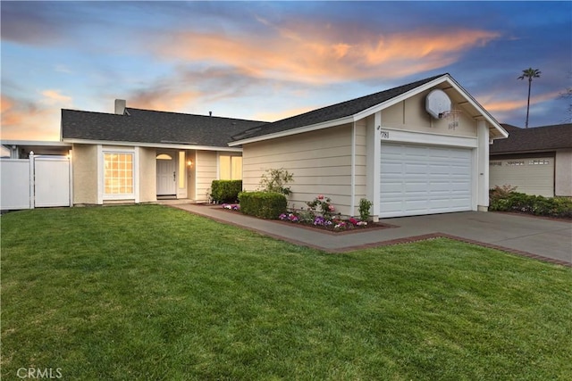 ranch-style home featuring fence, roof with shingles, an attached garage, concrete driveway, and a yard