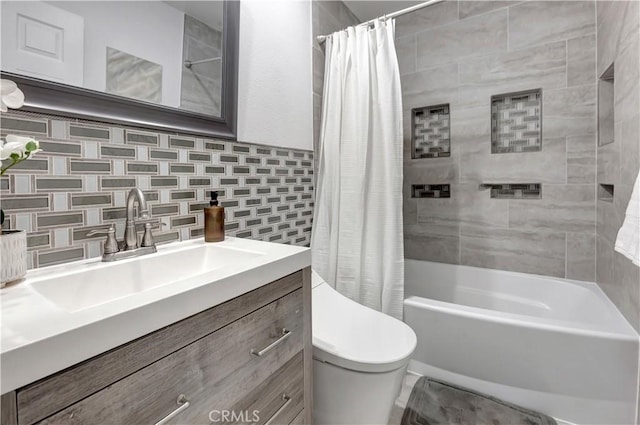 full bathroom featuring vanity, shower / bath combo, toilet, and tasteful backsplash