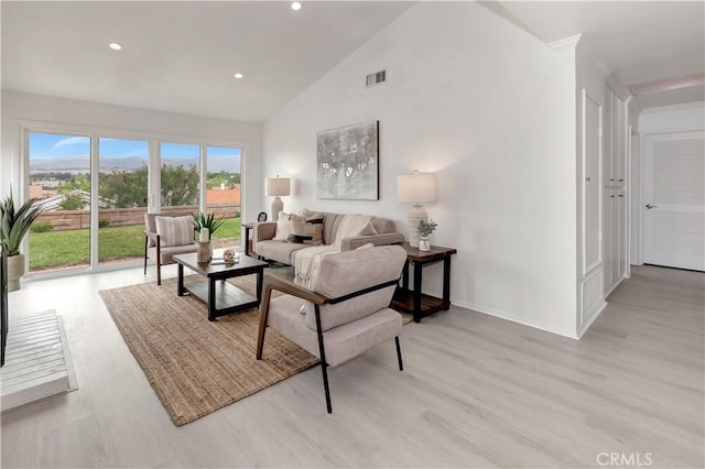 living area with visible vents, baseboards, high vaulted ceiling, recessed lighting, and light wood-style flooring