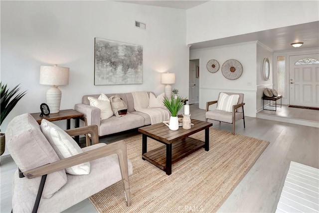 living room featuring visible vents and wood finished floors
