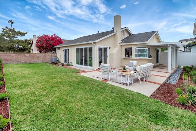 back of house featuring a patio, a fenced backyard, stucco siding, a lawn, and central air condition unit