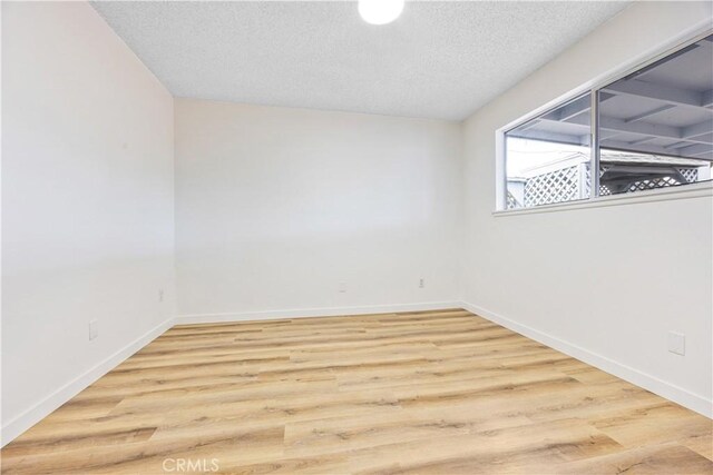 20908 New Hampshire Ave, Torrance, CA 90502 - empty room with a textured ceiling, wood finished floors, and baseboards