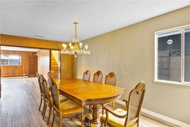 20908 New Hampshire Ave, Torrance, CA 90502 - dining room with stairway, baseboards, wood finished floors, a chandelier, and a textured ceiling