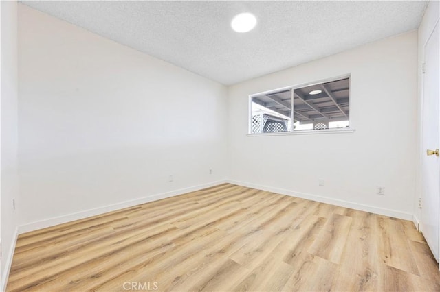 20908 New Hampshire Ave, Torrance, CA 90502 - empty room with wood finished floors, a textured ceiling, and baseboards