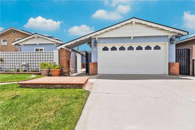 20908 New Hampshire Ave, Torrance, CA 90502 - view of front facade with brick siding, driveway, an attached garage, and a front lawn