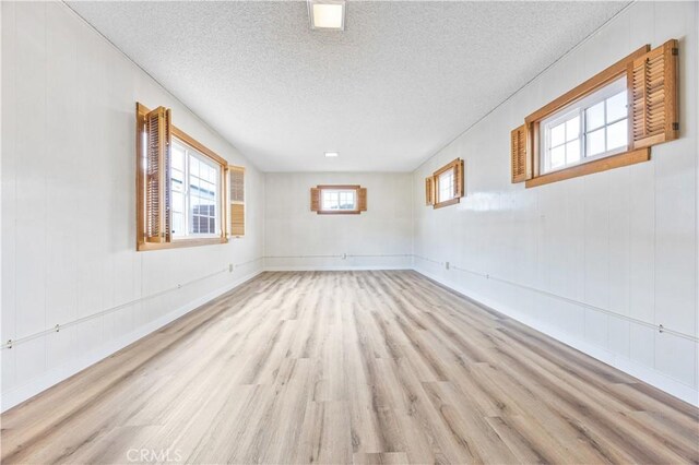 20908 New Hampshire Ave, Torrance, CA 90502 - empty room featuring light wood finished floors, a textured ceiling, and baseboards