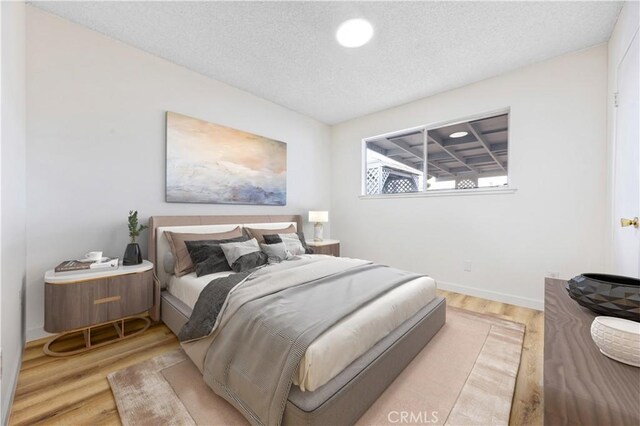 20908 New Hampshire Ave, Torrance, CA 90502 - bedroom featuring wood finished floors, a textured ceiling, and baseboards