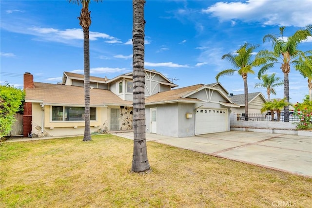 view of front of property with driveway, fence, a front lawn, an attached garage, and stucco siding