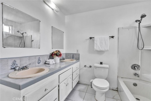 bathroom with double vanity, a sink, shower / bathtub combination, and toilet