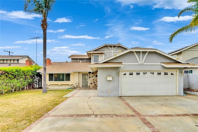 traditional-style home with a garage, fence, a front yard, stucco siding, and driveway