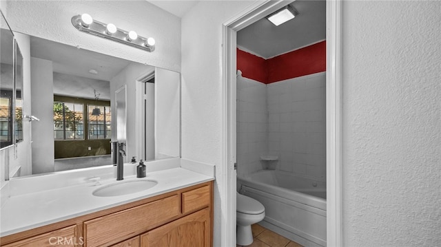 full bathroom featuring tile patterned flooring, a textured wall, toilet, and vanity