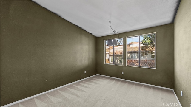 unfurnished dining area with baseboards and carpet flooring