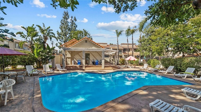 pool featuring fence and a patio area