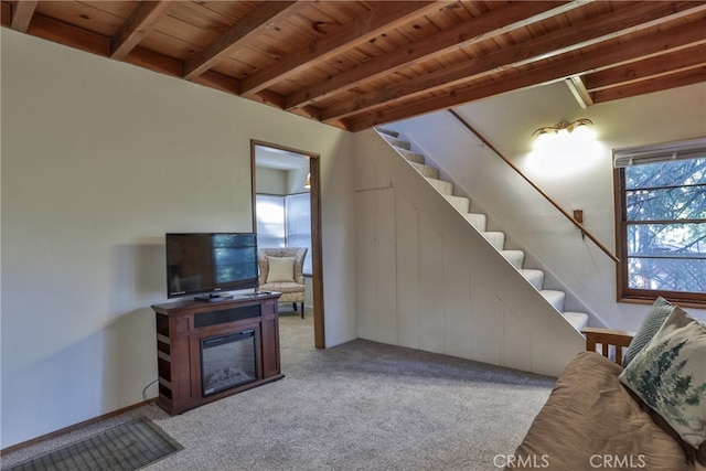 23800 Scenic Dr, Crestline, CA 92325 - carpeted living room with beamed ceiling, stairs, and wood ceiling