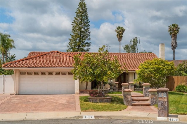 4397 N Skylark Ct, Moorpark, CA 93021 - view of front of home with fence, a tiled roof, an attached garage, and driveway