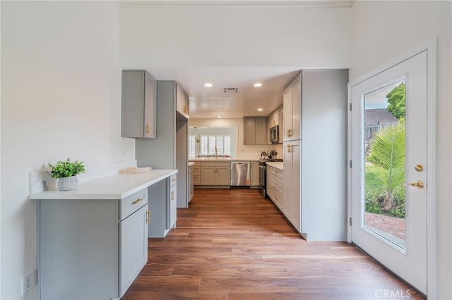 4397 N Skylark Ct, Moorpark, CA 93021 - kitchen featuring visible vents, wood finished floors, gray cabinetry, light countertops, and stainless steel appliances