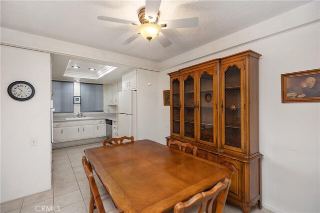 124 Via Estrada Unit D, Laguna Woods, CA 92637 - dining area featuring ornamental molding, light tile patterned flooring, ceiling fan, and a tray ceiling