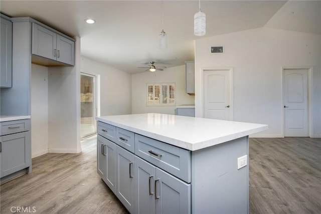 kitchen featuring a ceiling fan, gray cabinets, lofted ceiling, and visible vents