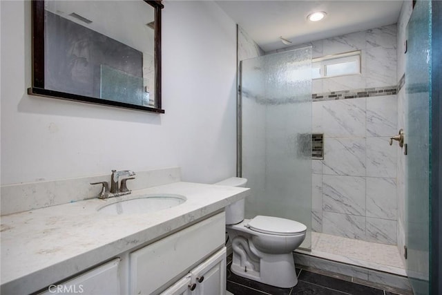 full bathroom with toilet, a tile shower, and vanity