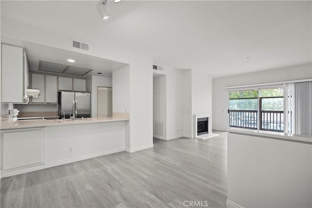2960 Champion Way Unit 2706, Tustin, CA 92782 - kitchen featuring freestanding refrigerator, light wood finished floors, baseboards, and visible vents