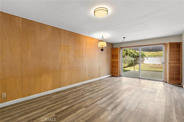 851 Crest Vista Dr, Monterey Park, CA 91754 - empty room featuring wood walls, wood finished floors, and baseboards