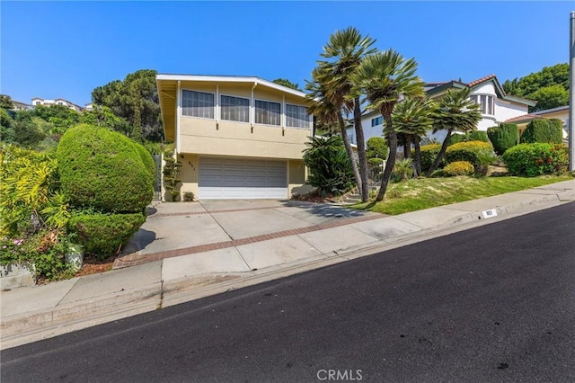 851 Crest Vista Dr, Monterey Park, CA 91754 - view of front of house with concrete driveway, a garage, and stucco siding