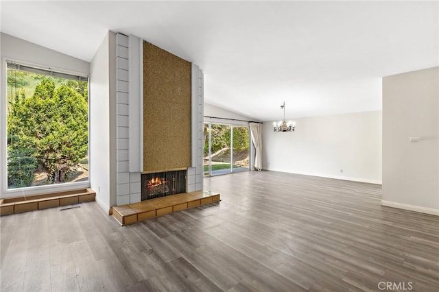 851 Crest Vista Dr, Monterey Park, CA 91754 - unfurnished living room featuring baseboards, vaulted ceiling, wood finished floors, a tiled fireplace, and a notable chandelier