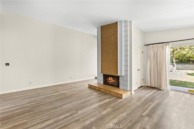 851 Crest Vista Dr, Monterey Park, CA 91754 - unfurnished living room with baseboards, wood finished floors, and a tiled fireplace