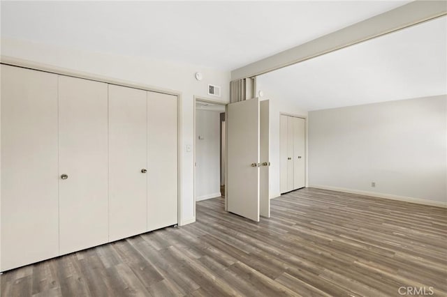 851 Crest Vista Dr, Monterey Park, CA 91754 - unfurnished bedroom featuring two closets, lofted ceiling, visible vents, baseboards, and wood finished floors