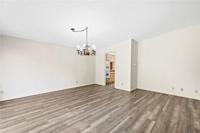 851 Crest Vista Dr, Monterey Park, CA 91754 - unfurnished room with a chandelier, baseboards, wood finished floors, and lofted ceiling