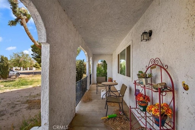 view of patio featuring a balcony