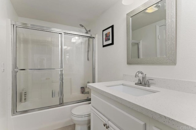 full bath featuring visible vents, shower / bath combination with glass door, toilet, and vanity